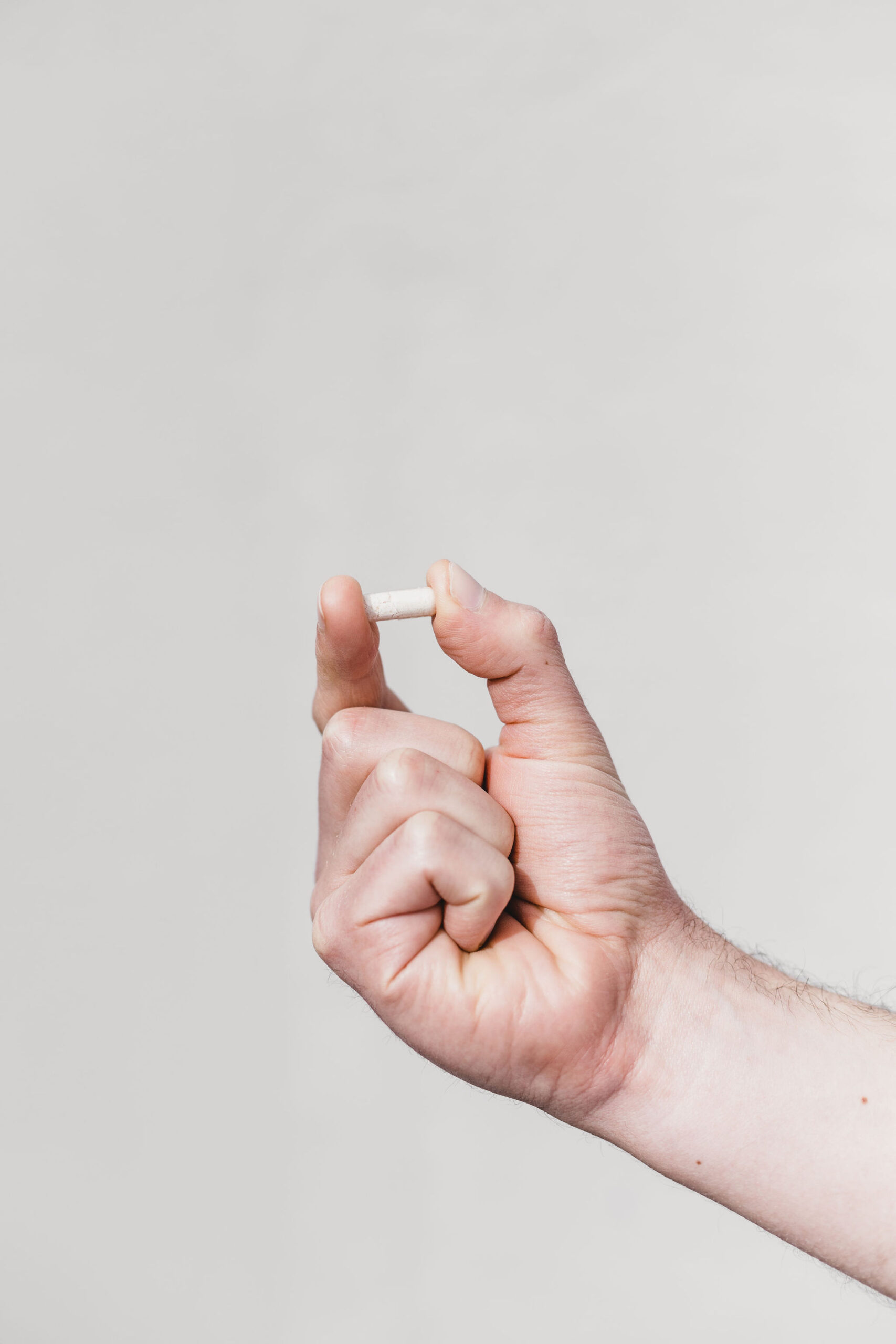 Hand holding a pill