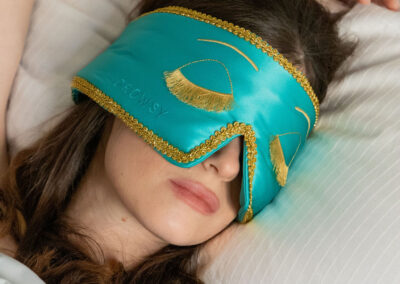 Image of a woman wearing a Drowsy sleep mask