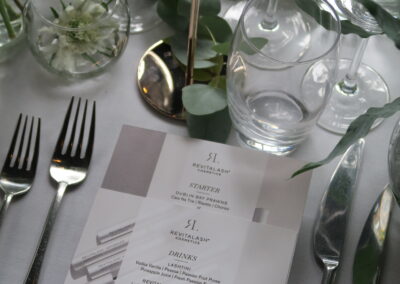 Image of a table setting with plate and cutlery and promotional material