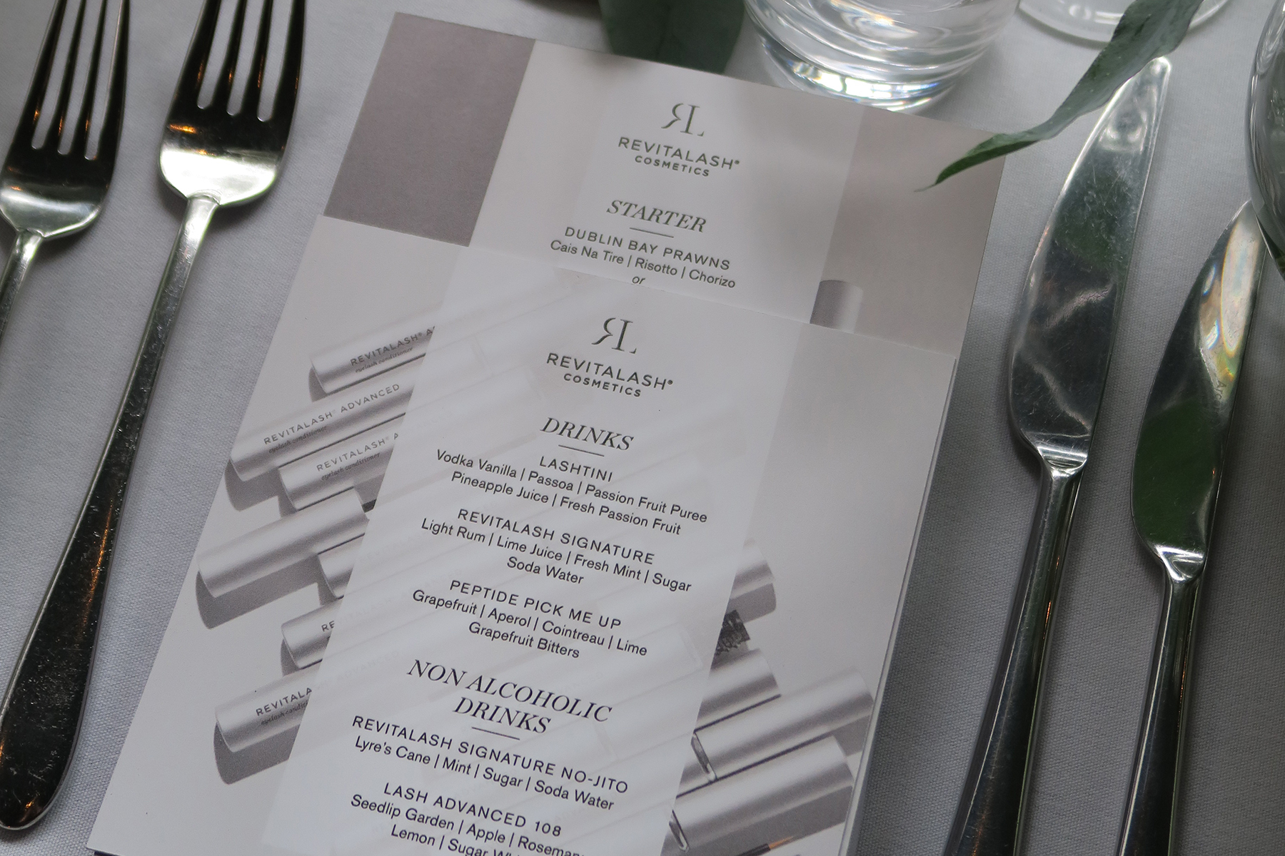 Image of a table setting with plate and cutlery and promotional material