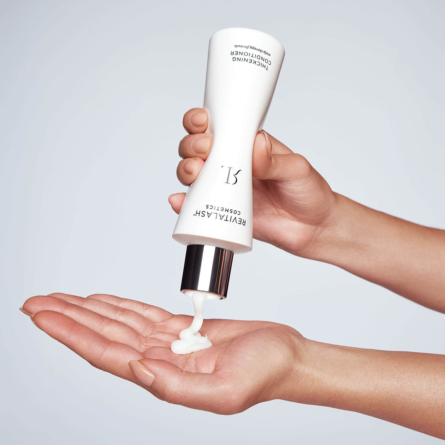 application-images-Conditioner-Step-1 hair conditioner squirted into a hand